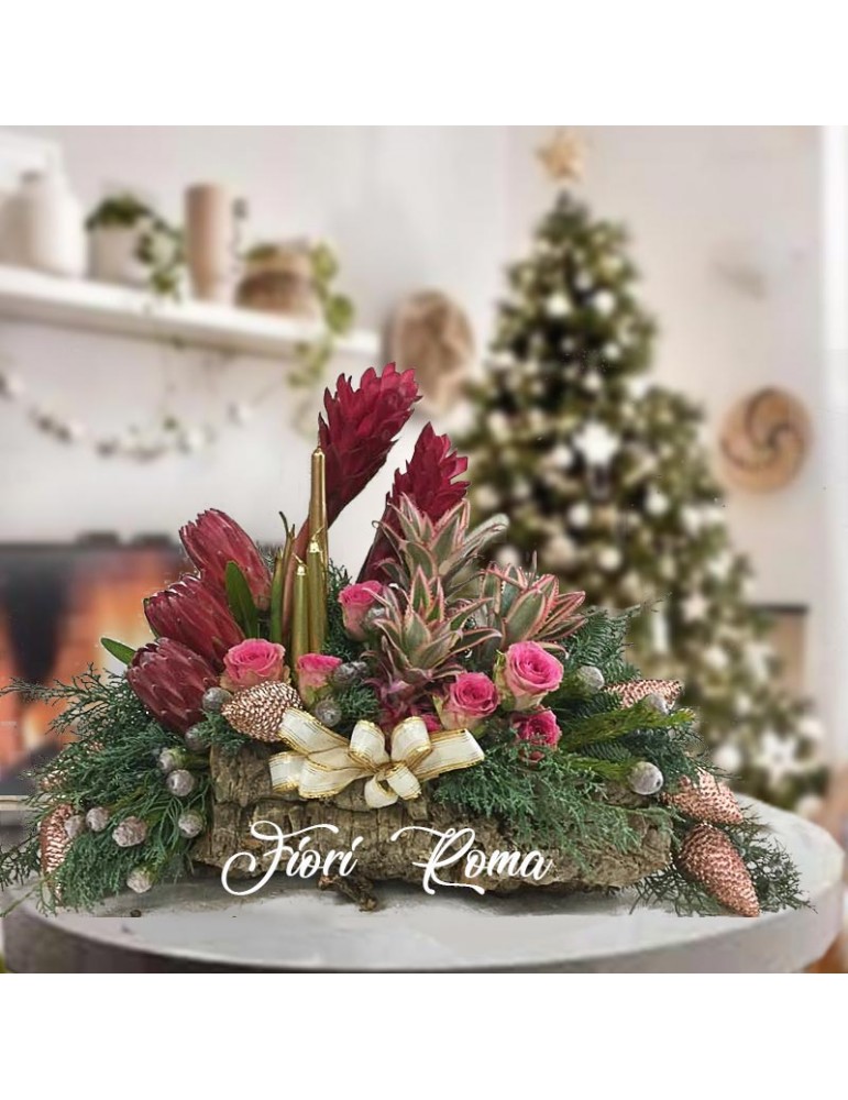 Centerpiece on bark with proteas, pink roses, ginger, pineapple, Christmas decorations
